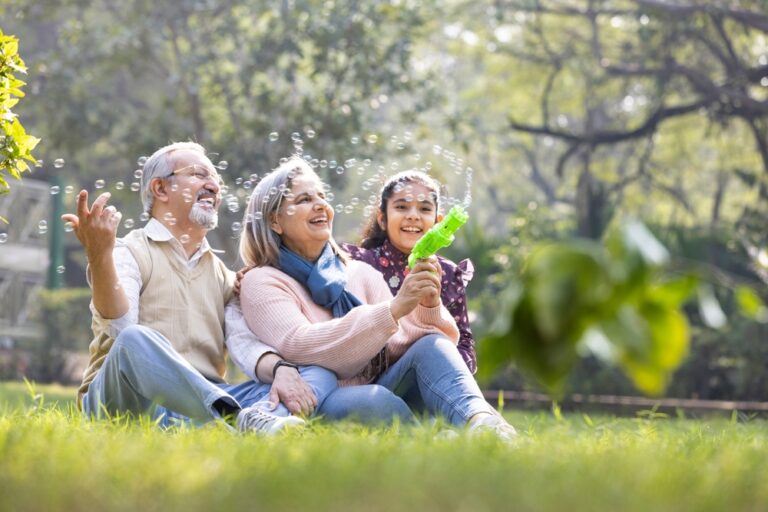 Grandparents,,Bubbles,And,Children,Play,In,Park,Happy,Together,For